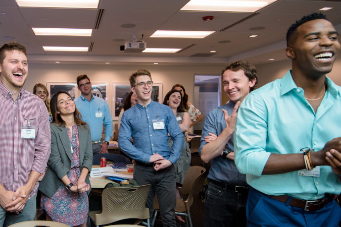 A group of smiling, cheering people